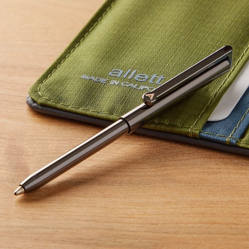Allett micro pen in gunmetal grey shown next to a wallet