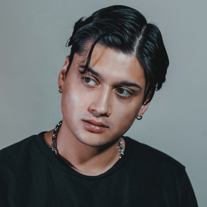 Dark side-parted hair styled with Modify Pomade, on-model lifestyle shot
