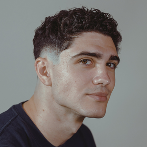 Short curly top with faded sides, styled with Modify Pomade
