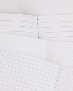Close-up of lined, dot grid, and graph paper inside Natural Science Pocket Notebooks – sustainable pocket journals from The Simple Man