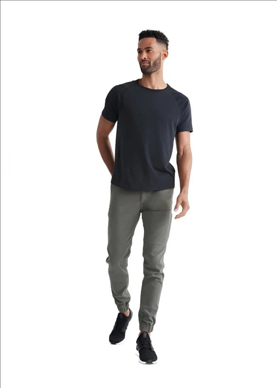 Model wearing Duer No Sweat Jogger pant in Thyme color, front  view