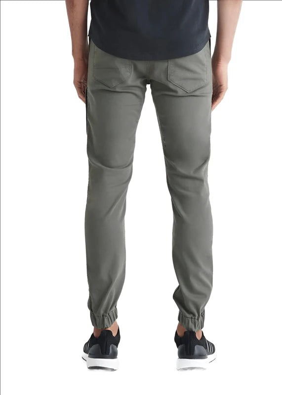 Model wearing Duer No Sweat Jogger pant in Thyme color, rear view