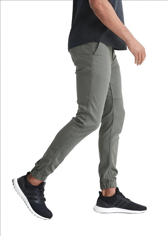 Model wearing Duer No Sweat Jogger pant in Thyme color, side  view