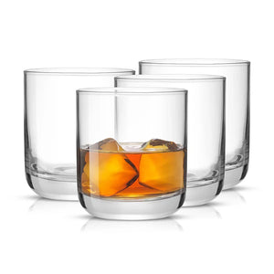 JoyJolt Nova old fashioned whiskey glass set of 4 on white background – lead-free crystal 10oz tumblers one filled with bourbon on the rocks