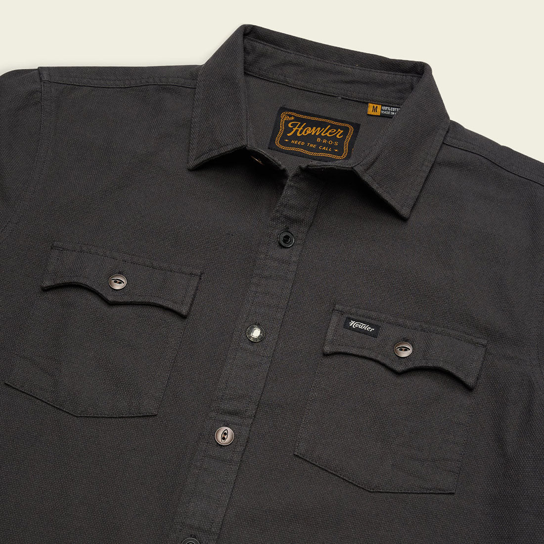 Close-up of collar and dual chest pockets on the Novato Shirt in Antique Black, charcoal grey cotton dobby western shirt laid flat -- The Simple Man