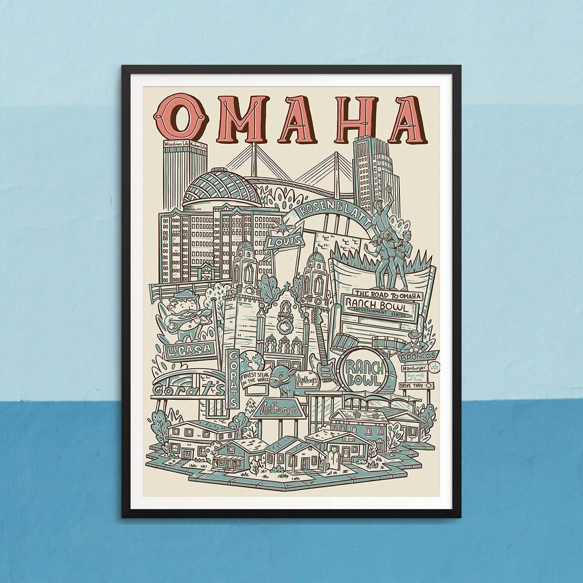 Framed Omaha city print by Caleb Morris featuring local icons like Bob Kerrey Bridge, Ranch Bowl, and Woodmen Tower. Available at The Simple Man.