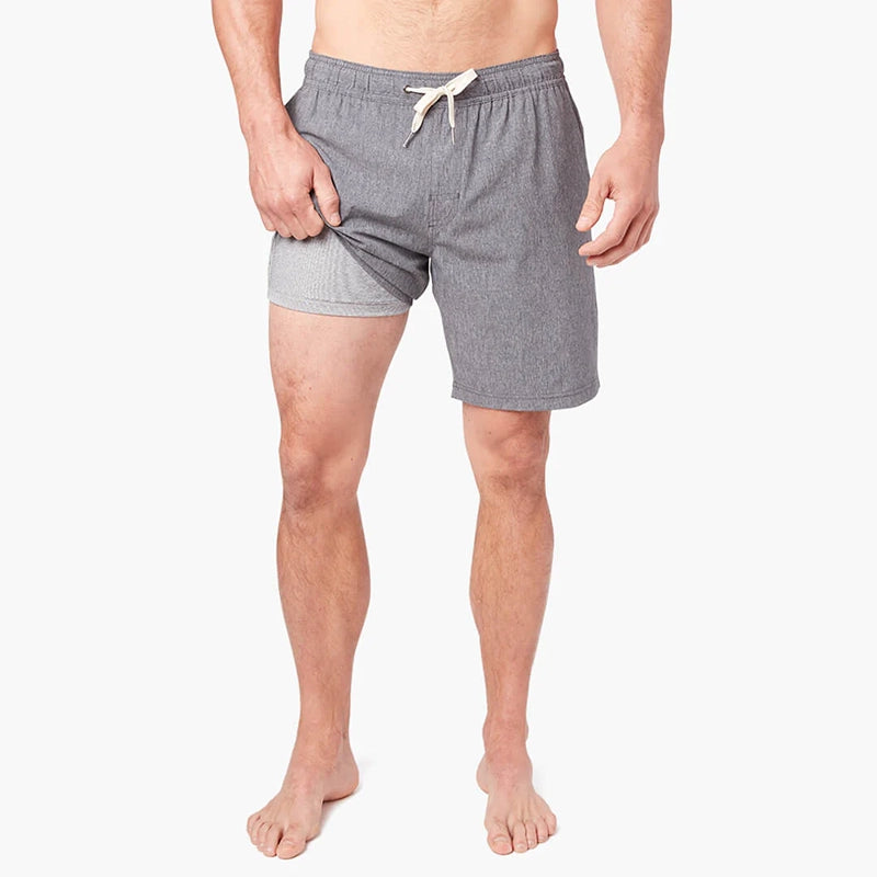 Model Wearing Fair Harbor One Short in Grey, front view with leg up showing liner