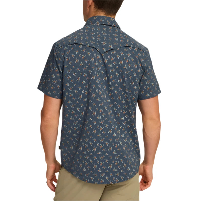 Model wearing Howler Brothr's Open Country Tech shirt in the Rancher floral - dark Slate option, rear  view