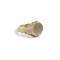 Otto Signet Ring in brass with an octagonal brushed face and faceted shank on a white background