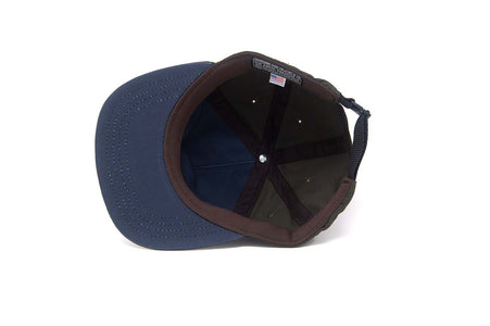 Inside view of the OUTSIDERS Dry Wax Strapback showing the canvas lining, Koolnit sweatband, and adjustable nylon strap.