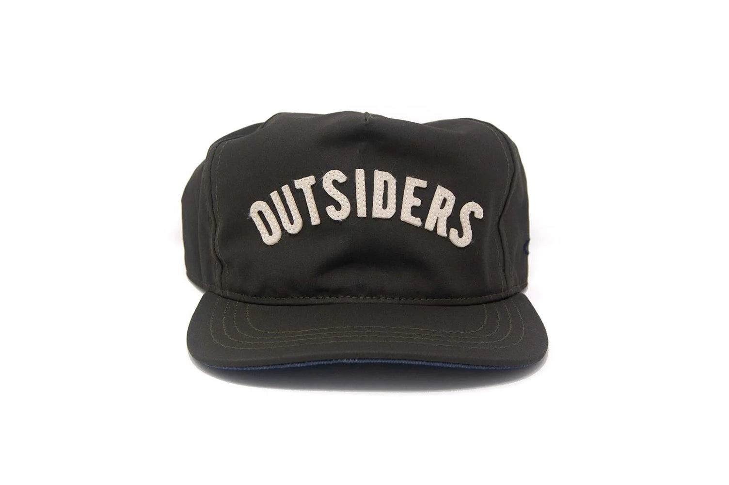 Front view of the OUTSIDERS Dry Wax Strapback with cream felt appliqué lettering on a black dry wax sailcloth cap