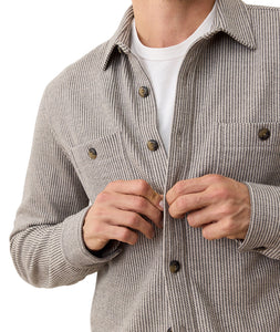 Man buttoning Pacifica Stretch Twill Overshirt in grey and black stripe pattern, made from breathable cotton-poly blend, classic fit shirt jacket