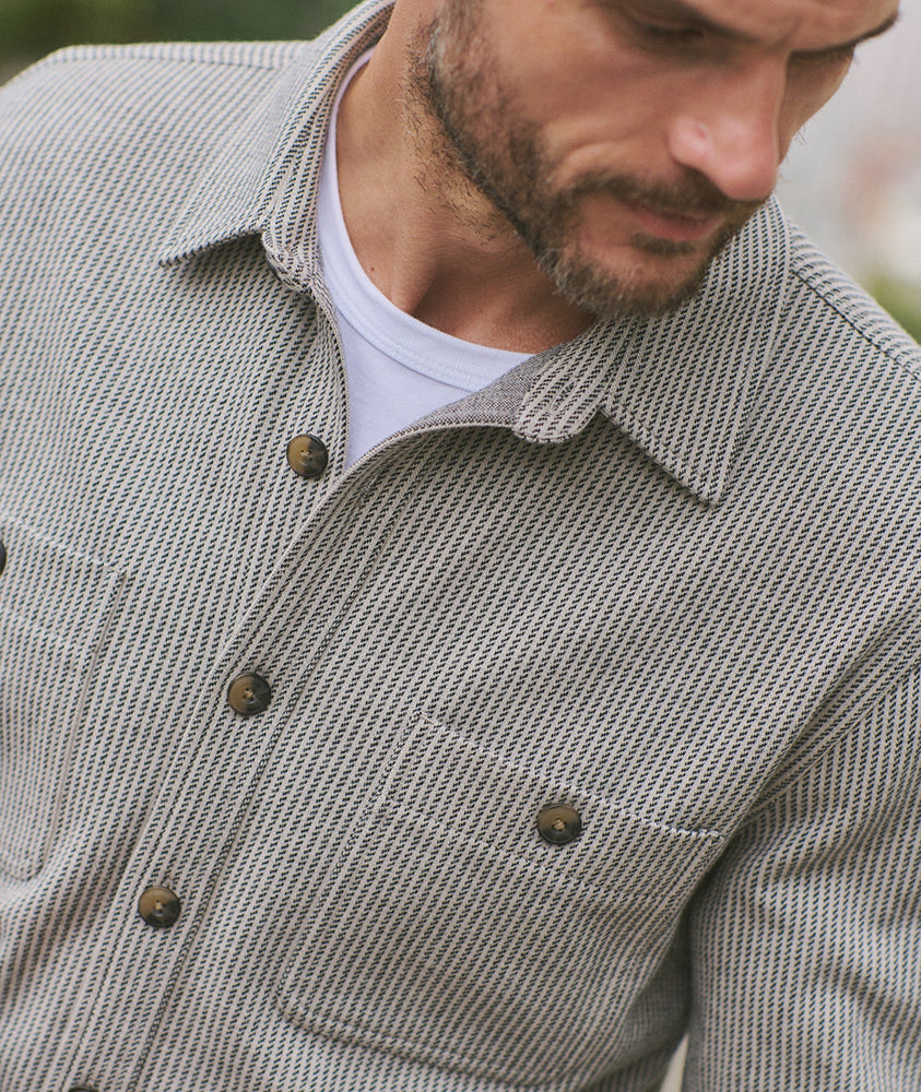 Close-up of Pacifica Stretch Twill Overshirt in grey railroad stripe pattern, featuring brass-tone buttons and textured stretch twill fabric – The Simple Man