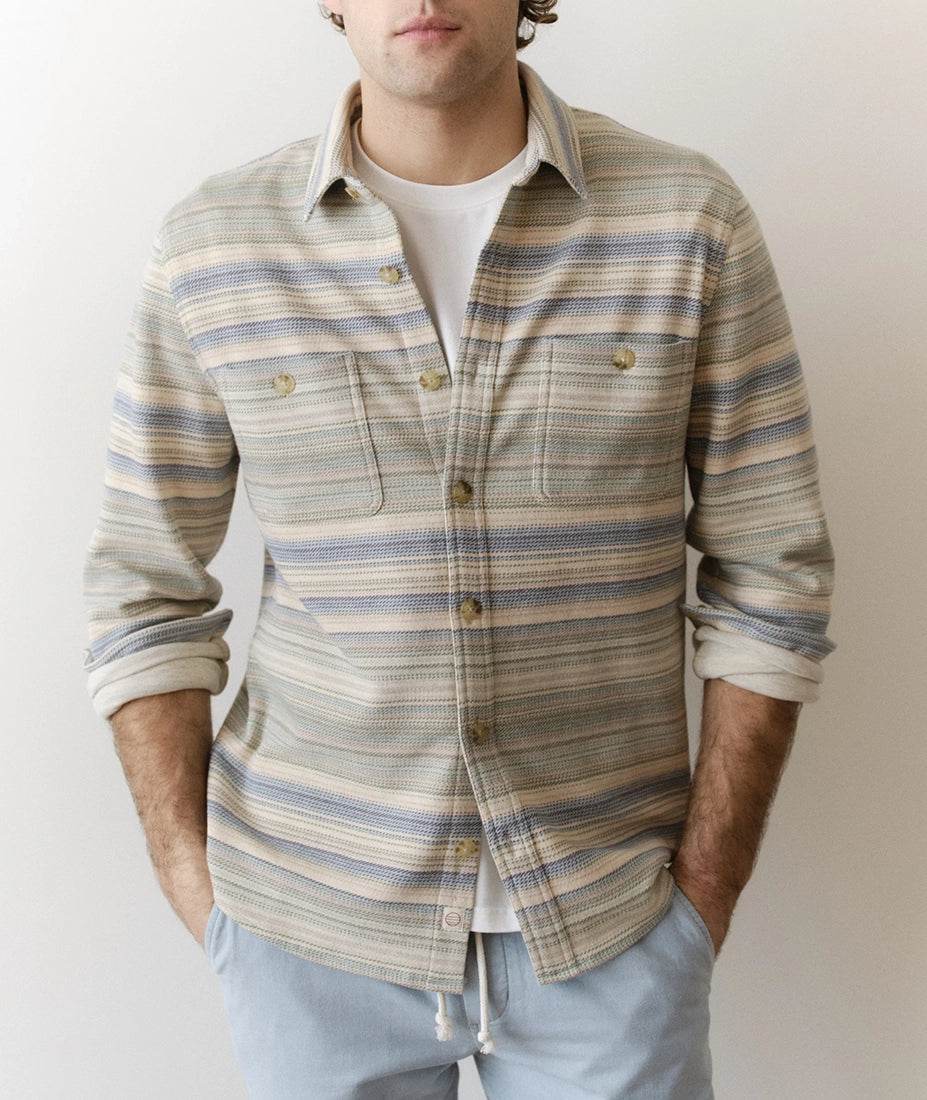 Man wearing a striped shirt with a plain background
