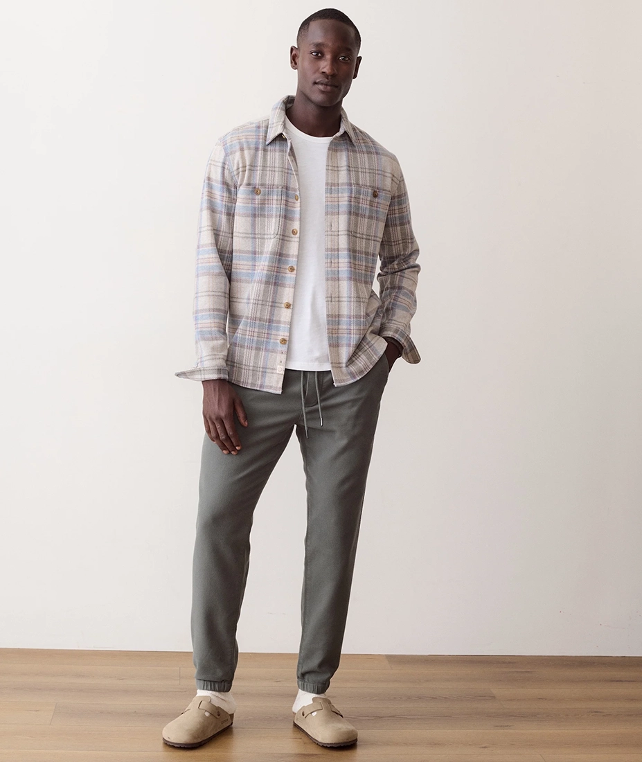 Man wearing Pacifica Stretch Twill Overshirt in Grey Plaid full length, styled with olive joggers and clogs - The Simple Man