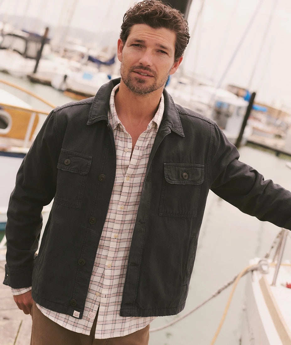Man wearing Faded Black overshirt over plaid shirt, lifestyle shot at the marina - The Simple Man