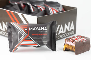 Mayana Chocolate Peppermint Mini Bar with wrapper and cut piece showing caramel, marshmallow, and candy cane topping.
