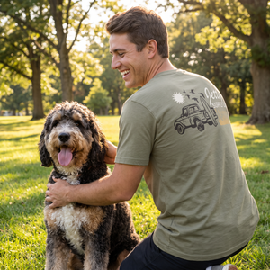 Man wearing military green graphic tee with truck and wordmark back print, Pickup Tee lifestyle outdoor shot - The Simple Man