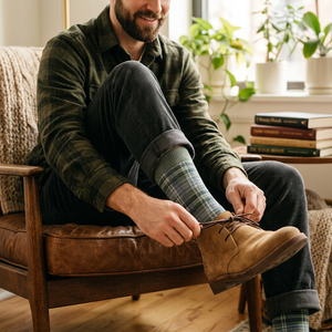 Man in flannel tying suede boots wearing Unsimply Stitched Plaid Stripe Sock in Teal Multi