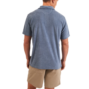 Model Wearing Howler Brothers Plusherman Terry Polo in Blue Mirage Color, rear view