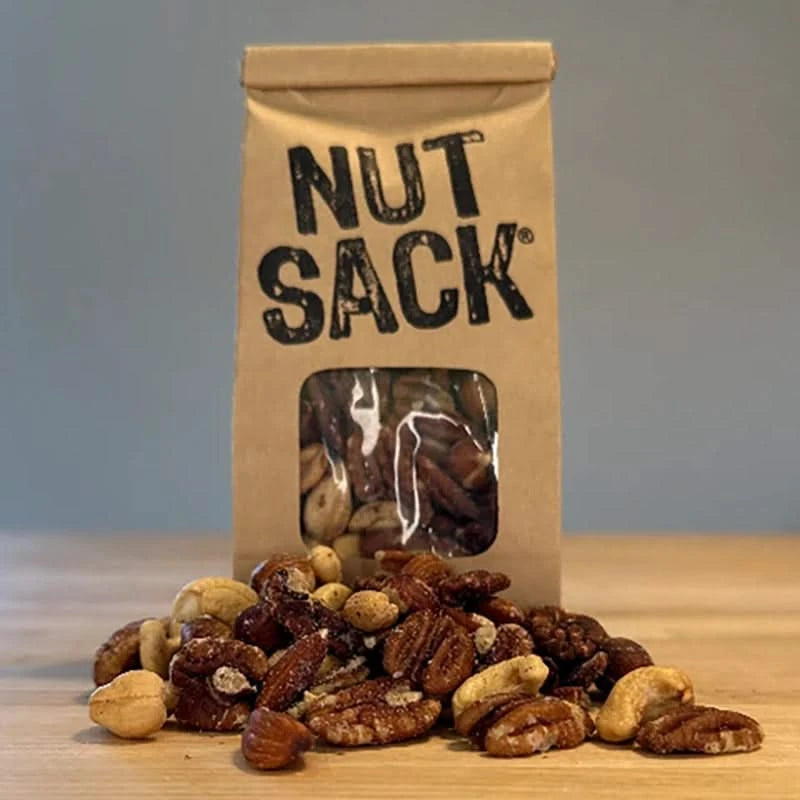 Nut Sack Premium Mix, snack bag of nuts, 6oz, front of bag with nuts on the table in front