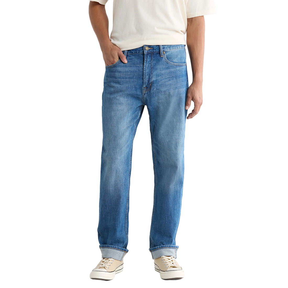 Front view on model of Pembridge wash Preston jeans worn with a cream tee and cuffed hems over sneakers