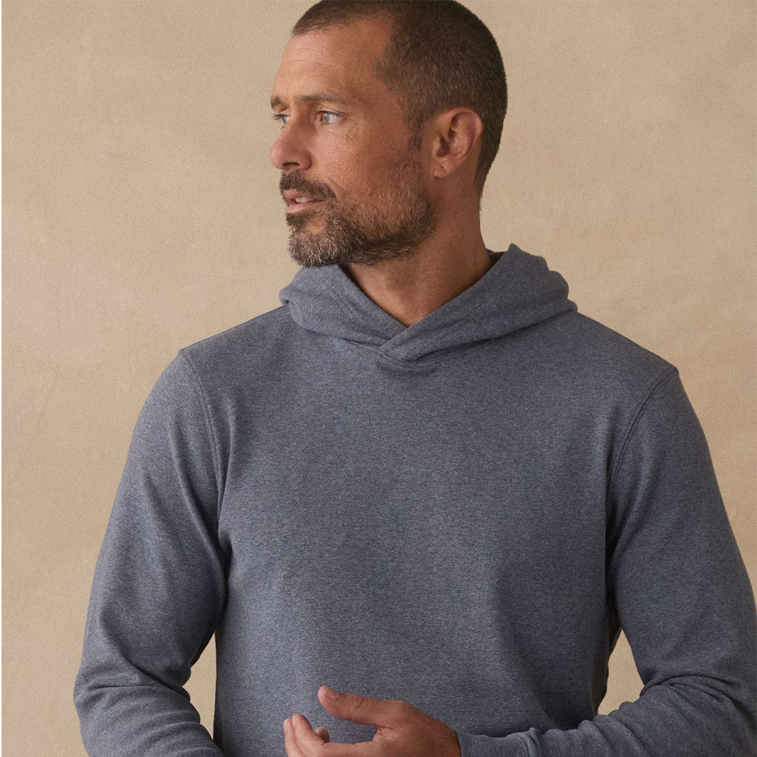 Man wearing Puremeso Essential Hoodie in Bluestone, close-up front view with hood down