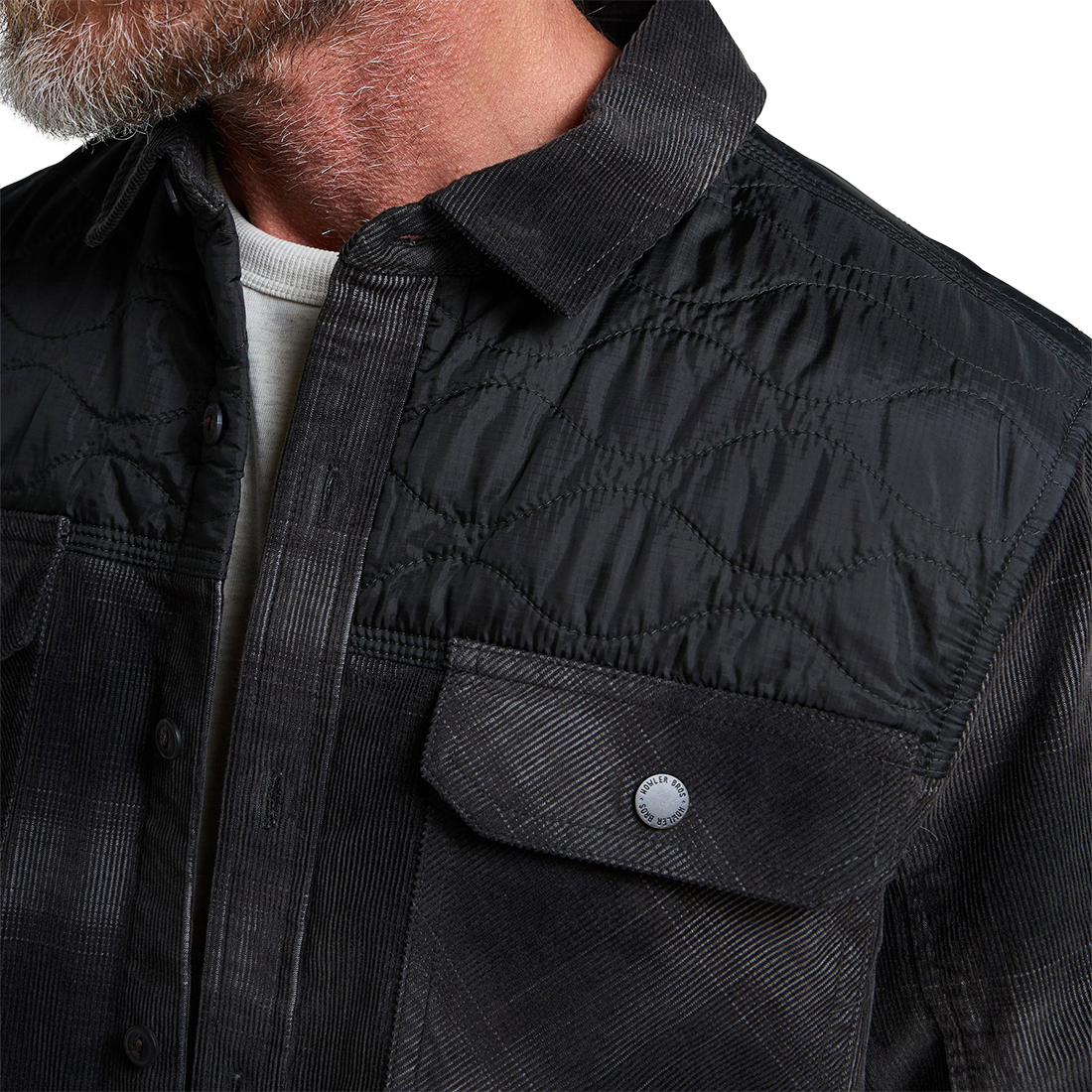 Close-up of the corduroy texture, quilted nylon yoke and Howler Bros snap chest pocket on the Quintana Quilted Shirt, The Simple Man