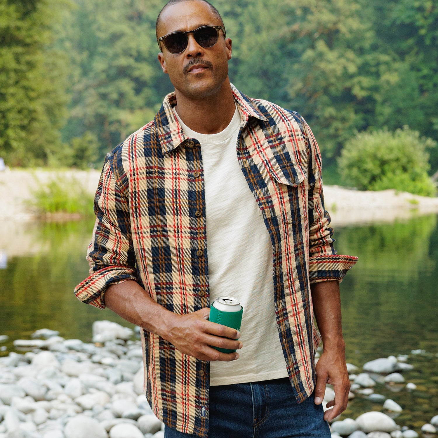 Heavy Twill Shacket in Navy Multi Plaid worn with jeans on a rocky riverbank - The Simple Man