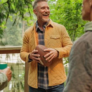 Camel corduroy quilted shacket styled with a plaid shirt, close-up of front - The Simple Man
