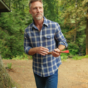 Man walking in the woods in Waffle Plaid Pearl Snap Shirt with sleeves rolled, navy plaid - The Simple Man