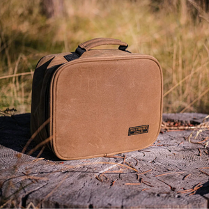Readywares Waxed Canvas Lunch Box, lifestyle shot outdoors on a tree stump