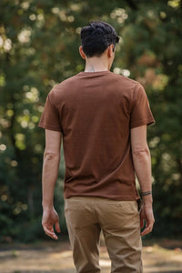 Man wearing Bridge and Burn Recycled Pocket Tee in bronze from behind – midweight recycled cotton men's t-shirt outdoor lifestyle

