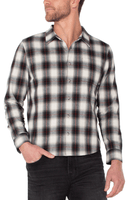 Man wearing brushed cotton Red / Black /White plaid button-up shirt with long sleeves and black jeans – rugged men’s fall shirt from The Simple Man.