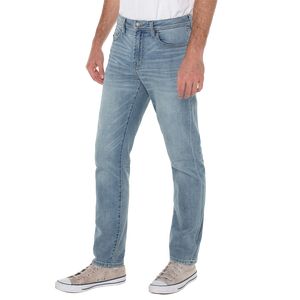 Three-quarter view on model of Palos Verdes wash relaxed straight jeans with a white tee and canvas sneakers