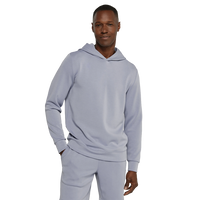 Light grey hoodie worn with hand adjusting the collar, front view - REV Hoodie in Thundercloud - The Simple Man
