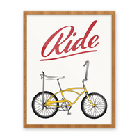 Framed Ride Stingray bike print with a yellow banana-seat bike and red script lettering on a white background, 11x14, The Simple Man