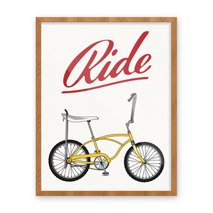 Framed Ride Stingray bike print with a yellow banana-seat bike and red script lettering on a white background, 11x14, The Simple Man