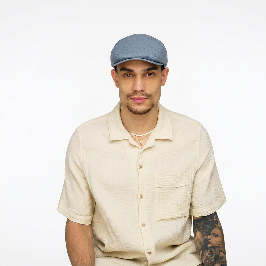 Roan Flat Cap Blue – front view on model wearing men's linen-look cotton flat cap with snap peak and comfort sweatband