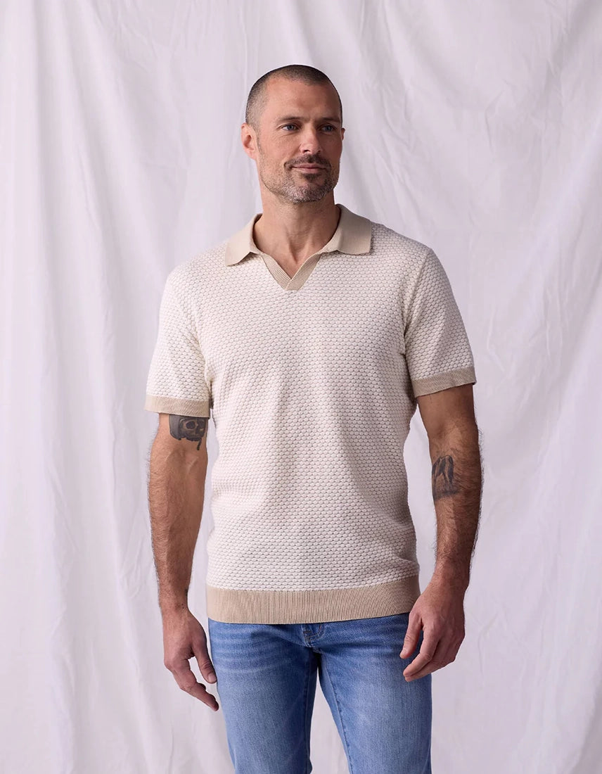 Man wearing The Normal Brand Robles Knit Jacquard Polo in ivory khaki – front view 100% cotton open placket polo tailored fit with jeans