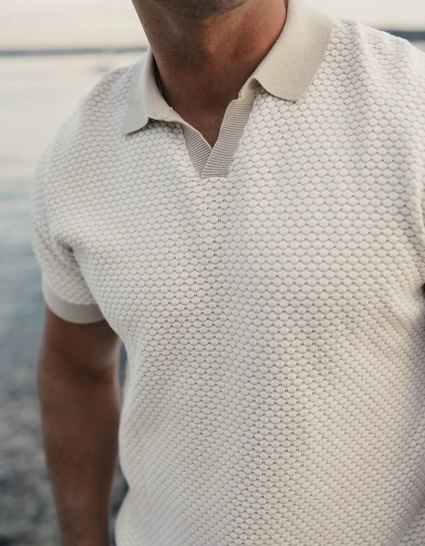 The Normal Brand Robles Knit Jacquard Polo close-up chest detail – ivory khaki micro jacquard texture contrast rib collar open placket men's polo