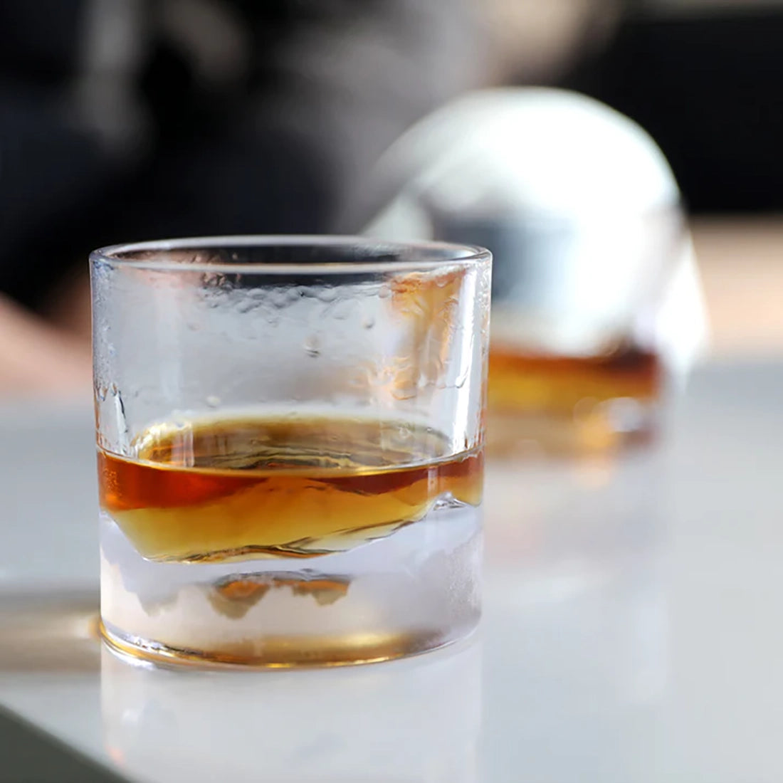 Rocky Mountains whiskey glass chilled from freezer with bourbon inside highlighting 3D mountain base design