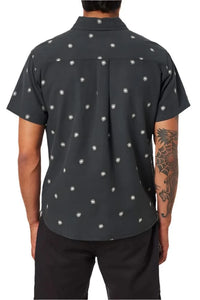 Back view of Shine Shirt worn by male model – black cotton linen short sleeve shirt with sun pattern and shirttail hem