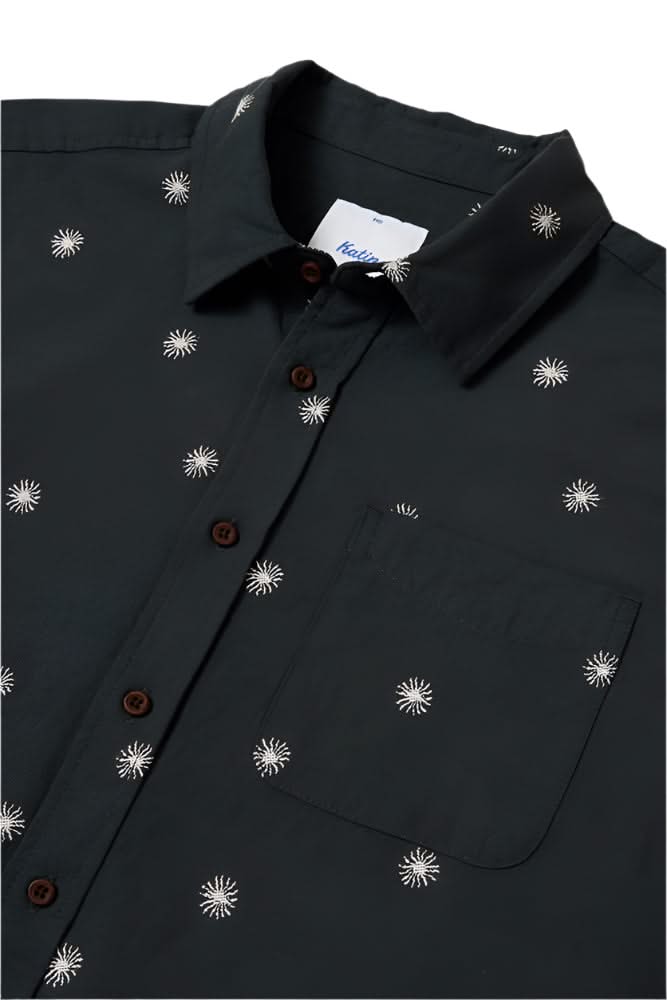 Close-up of black Shine Shirt with white sun graphic embroidery and chest pocket – breathable cotton linen men’s short sleeve button-up