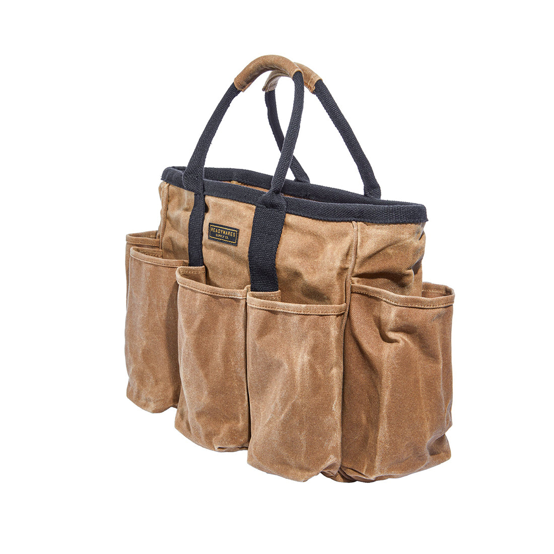 Readywares Supply Bag three-quarter view white background — 14-pocket 16oz waxed canvas tool tote with black cotton poly straps