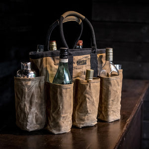 Readywares waxed canvas supply bag loaded with wine and spirits bottles — versatile 14-pocket utility tote used as bar bag