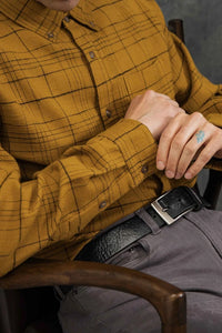 Close-up of Sutton Slim Shirt in mustard plaid showing button cuff and textured organic cotton fabric