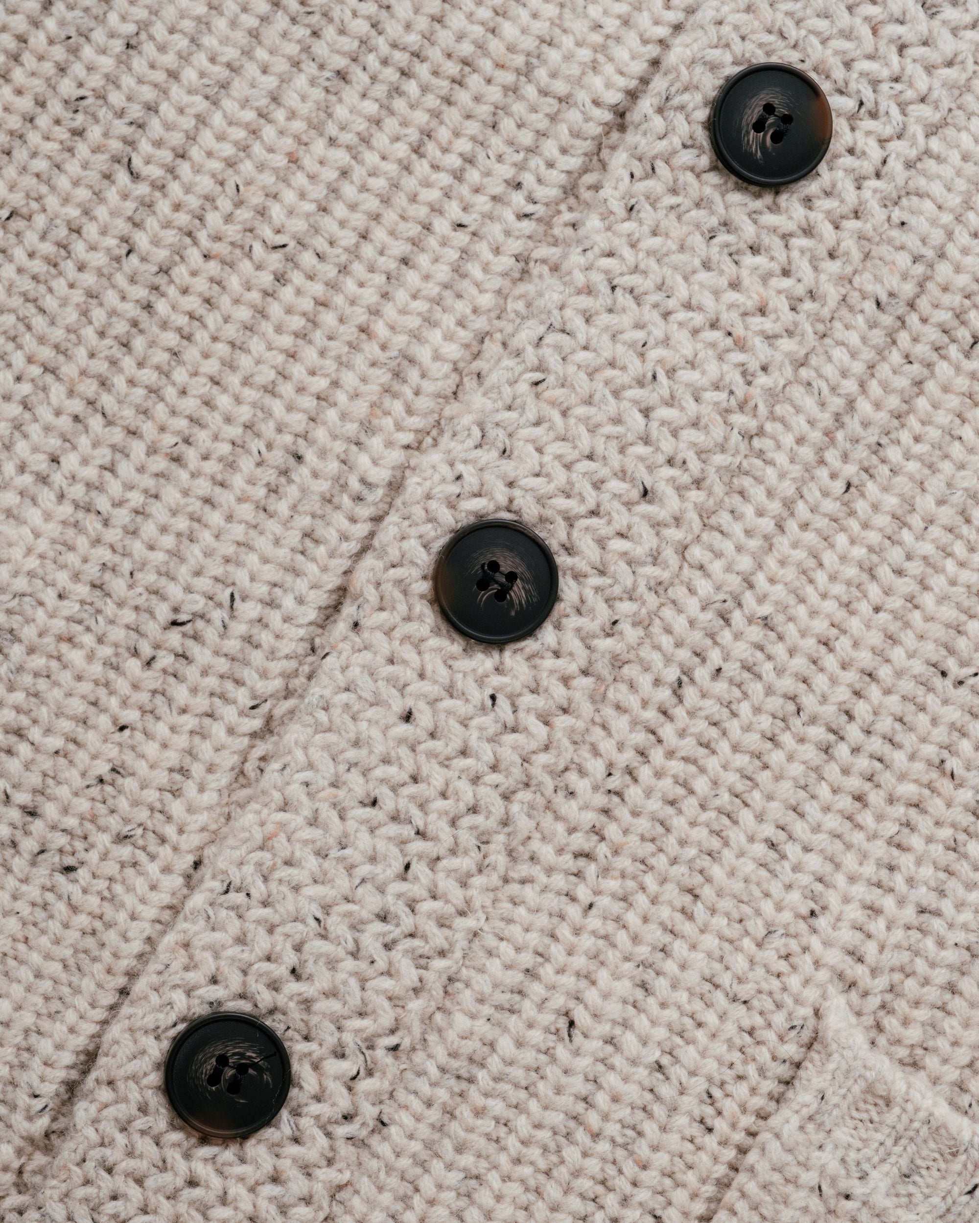 Shawl collar detail on an off white flecked Donegal wool blend cardigan - The Simple Man