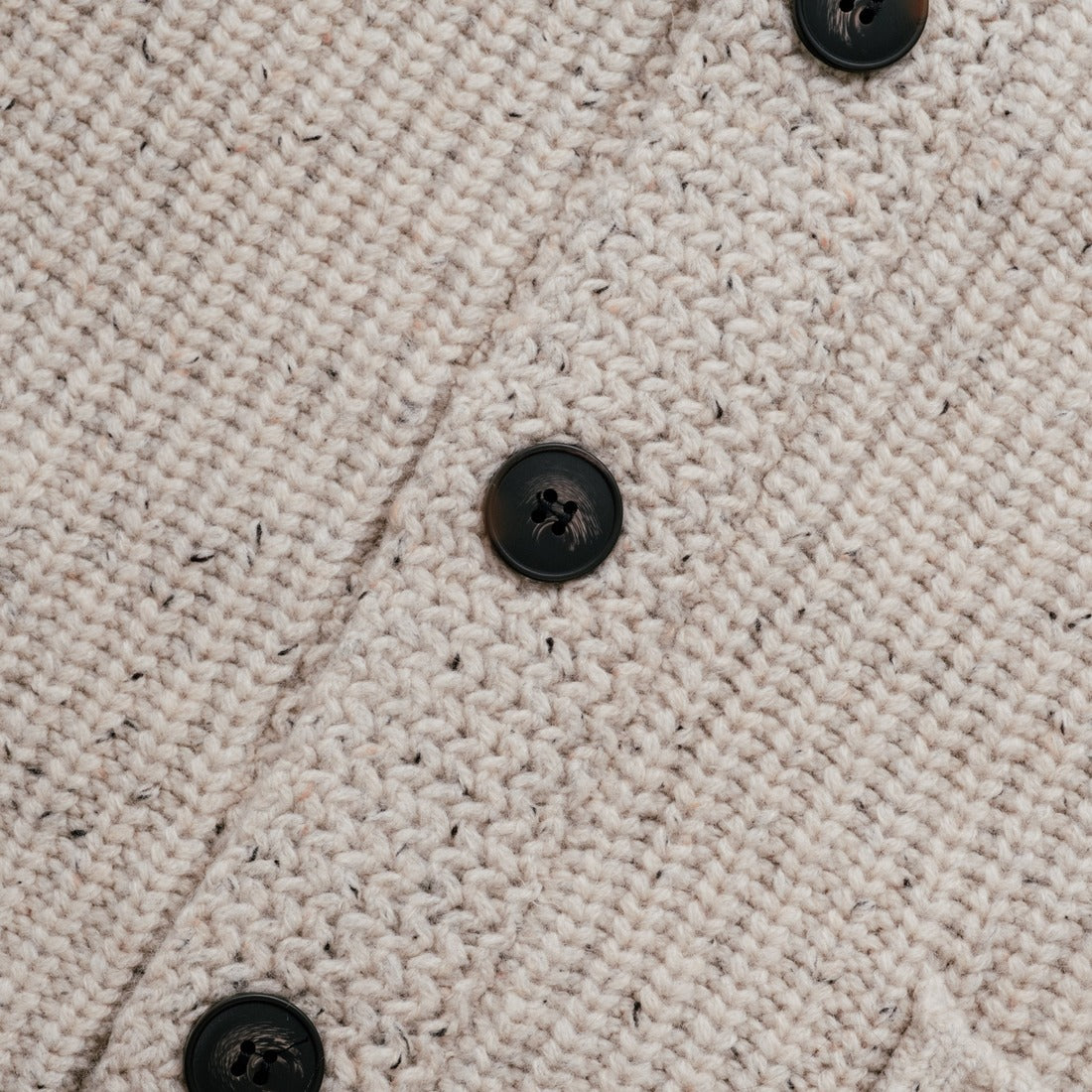 Shawl collar detail on an off white flecked Donegal wool blend cardigan - The Simple Man