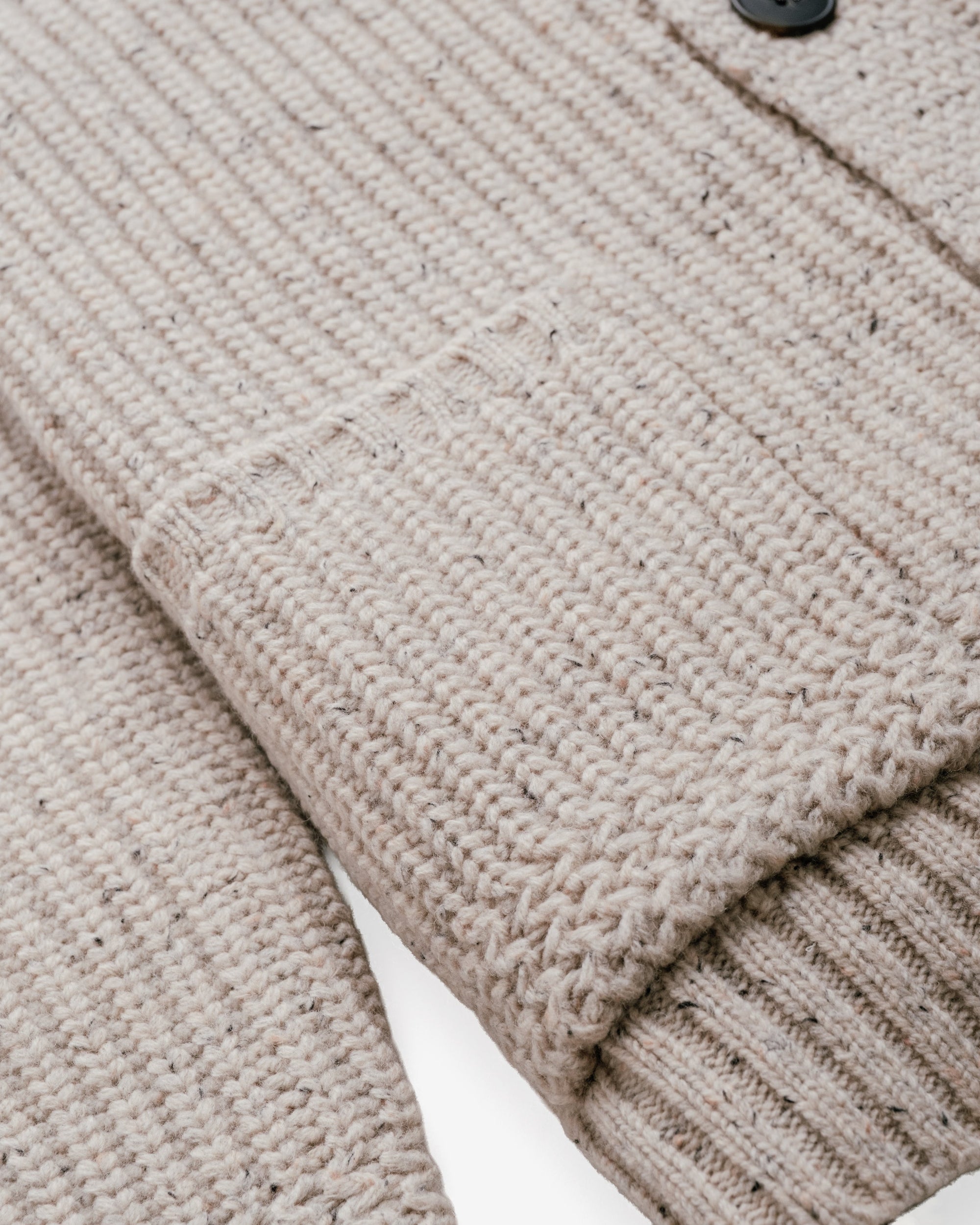 Five-button front detail on an off white ribbed Shaker knit cardigan - The Simple Man